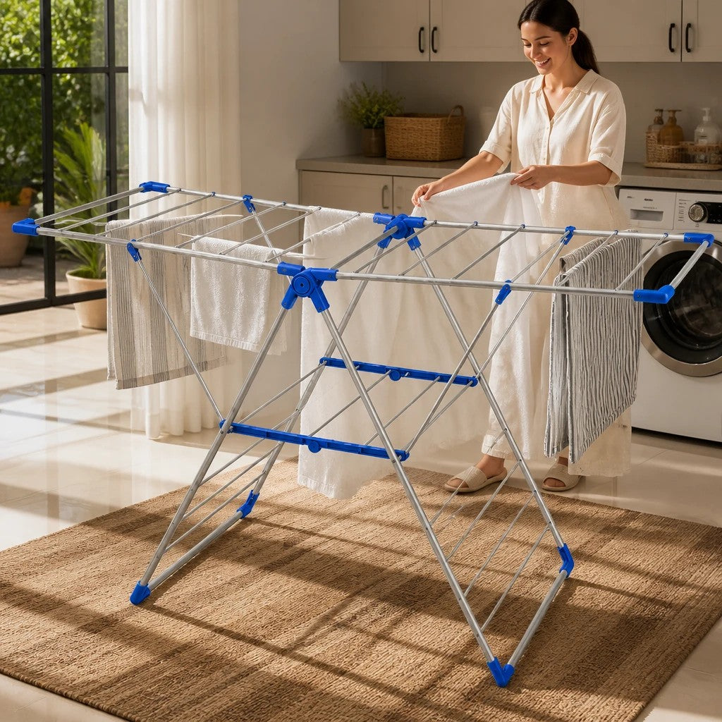 INOUTHOMECO foldable metal clothes drying rack with expandable blue-accented wings, holding laundry in a bright kitchen.