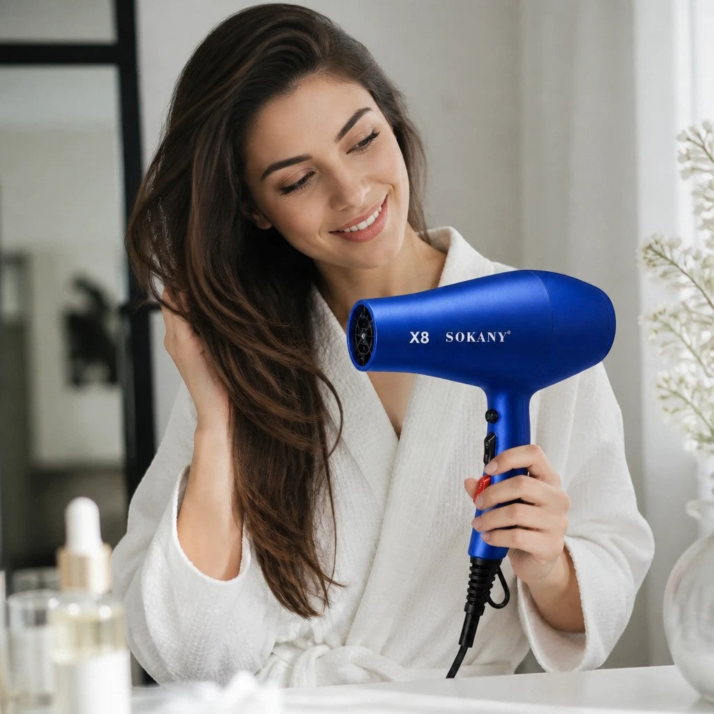 INOUTHOMECO Sokany X8 blue ionic hair dryer held by a smiling woman in a white robe for professional styling